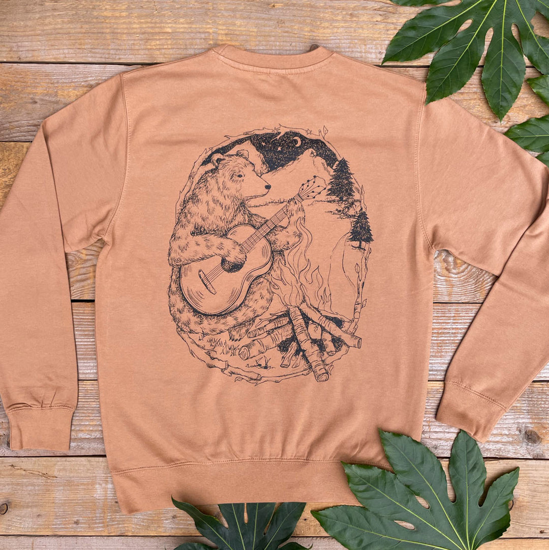 brown jumper with bear and mountains scene