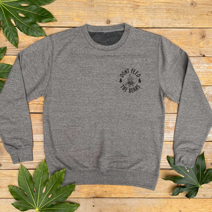 grey jumper with campfire design