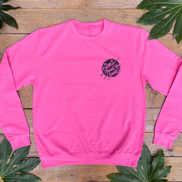 pink jumper with noodles logo