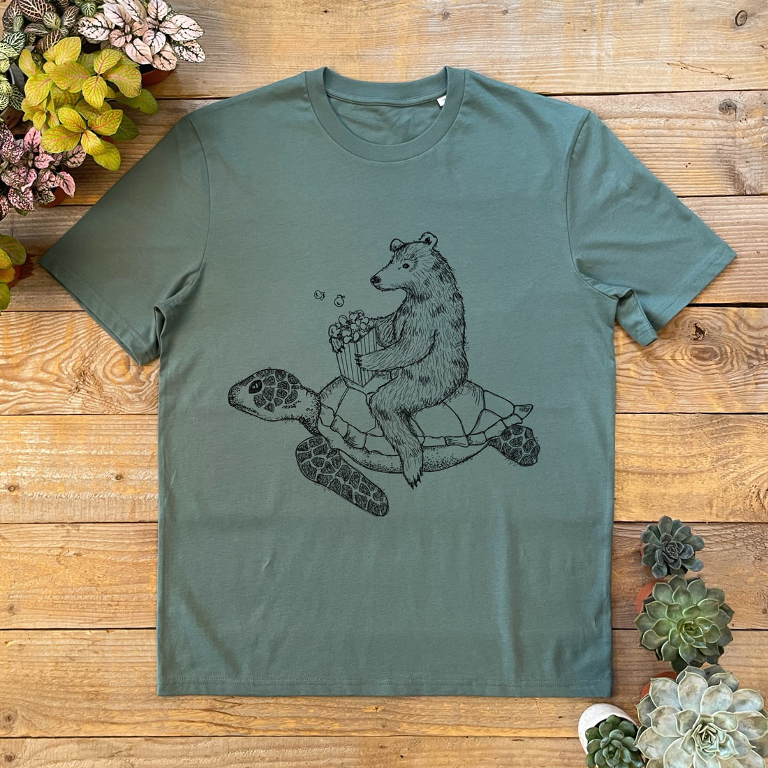 BEAR RIDING A TURTLE EATING POPCORN GREEN TEE