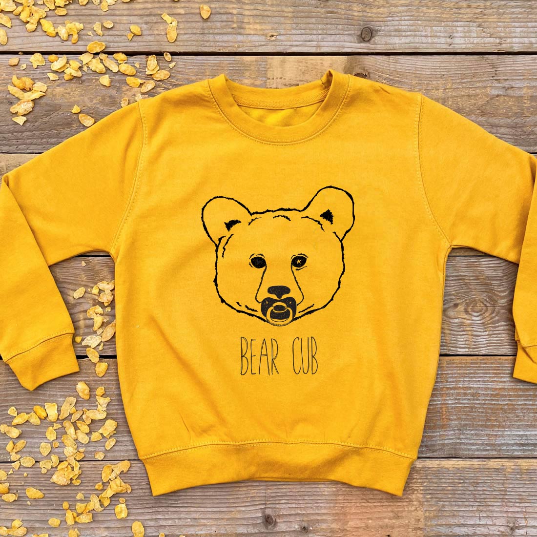 bear cub with dummy yellow jumper