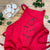 red apron with a bear dressed a s xmas pudding