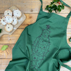 green apron with a bear dressed as xmas tree