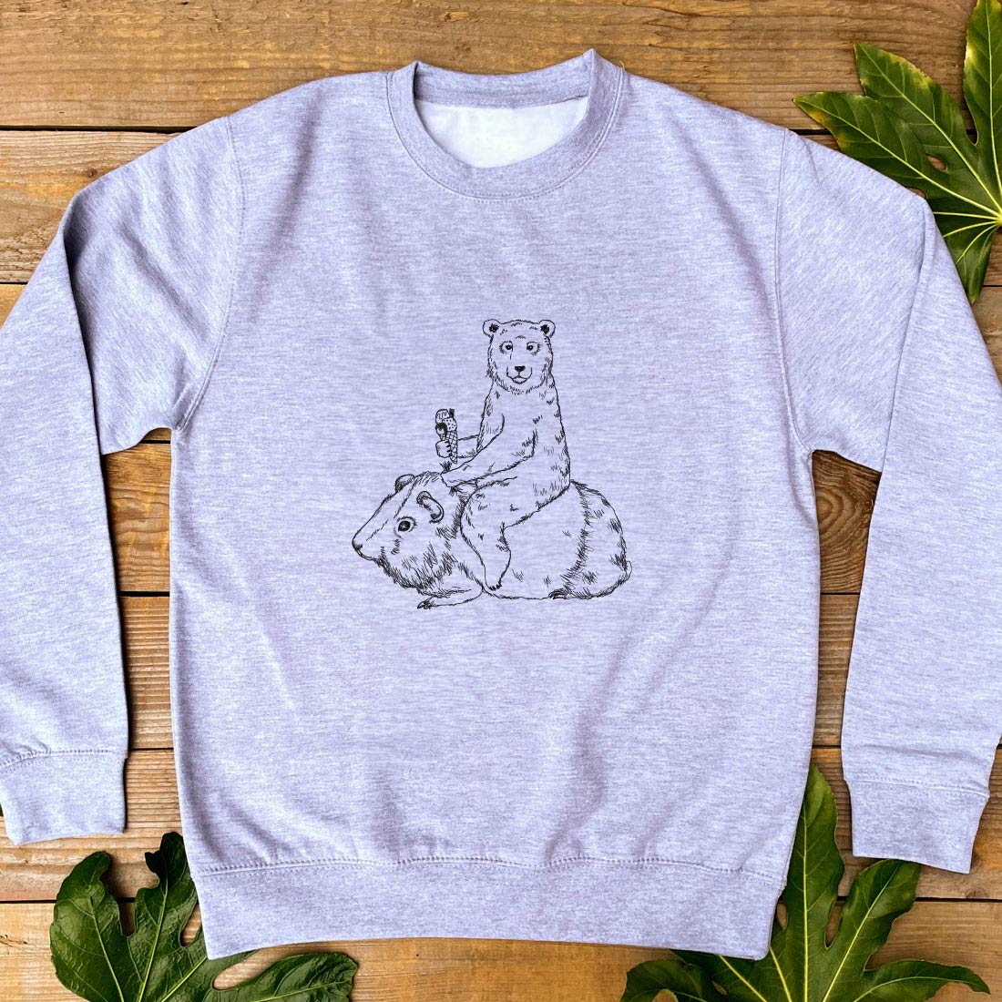 grey jumper with a bear and guinea pig design