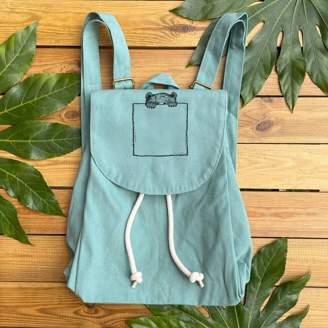 minty green backpack with mini bear