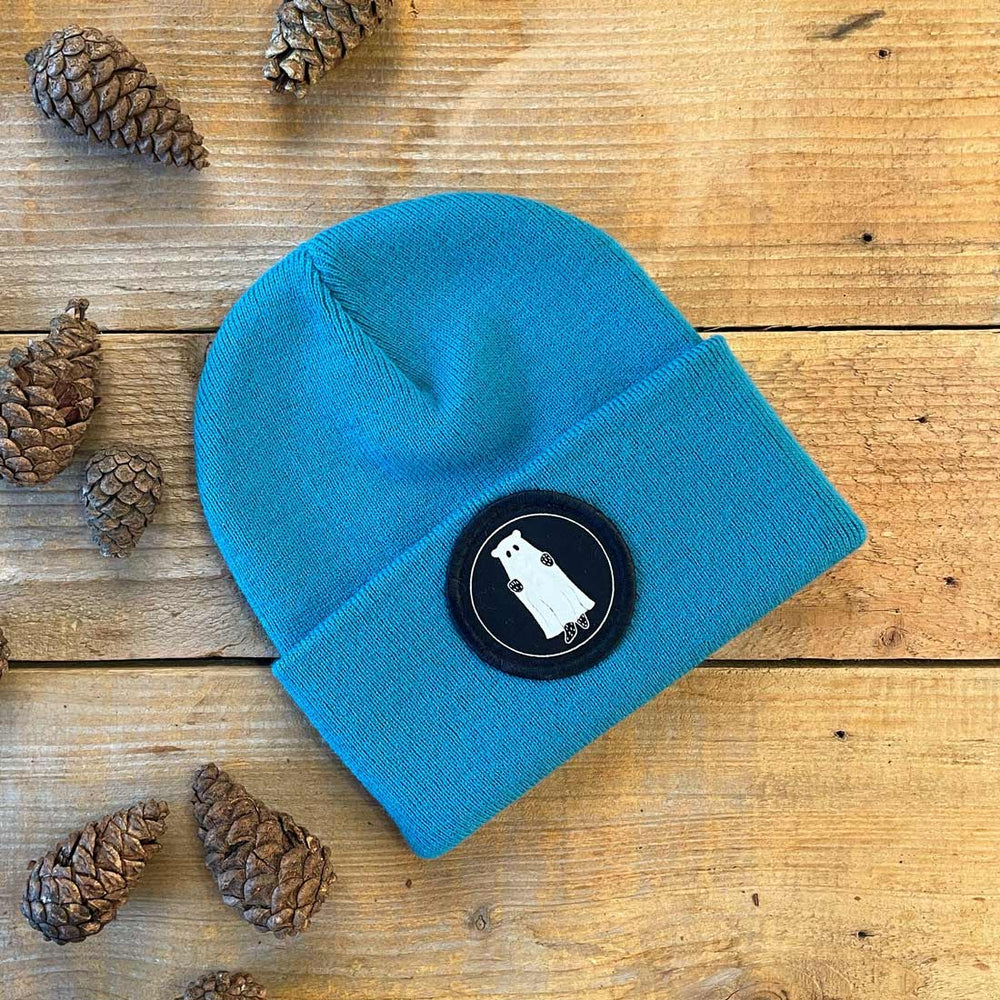teal beanie with ghost bear patch