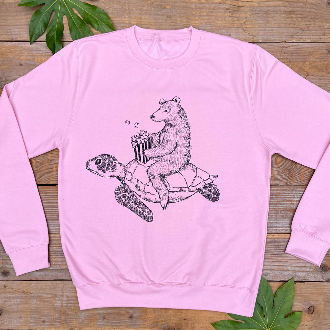 Pink jumper with bear riding turtle