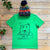 green christmas tee with bear on and hat
