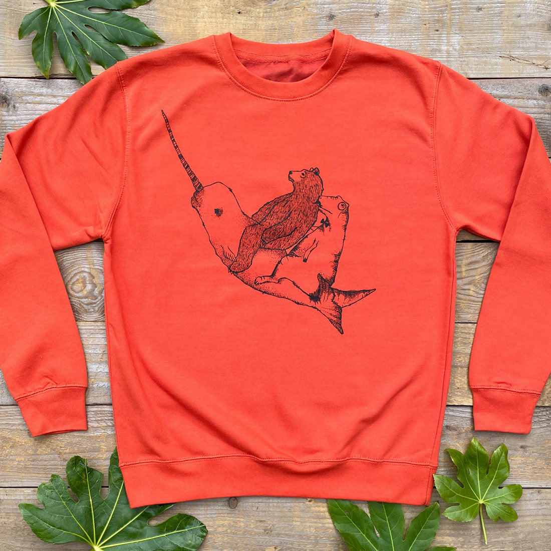 orange jumper with narwhal and bear 